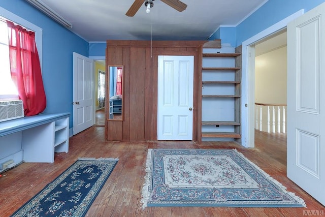 foyer entrance with a healthy amount of sunlight, ceiling fan, and dark hardwood / wood-style flooring