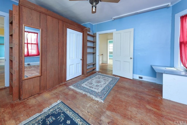 entrance foyer featuring dark hardwood / wood-style flooring, ceiling fan, and plenty of natural light