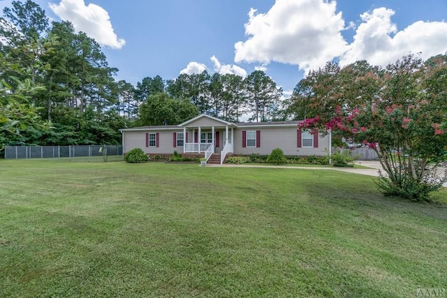 ranch-style home featuring a front yard and covered porch