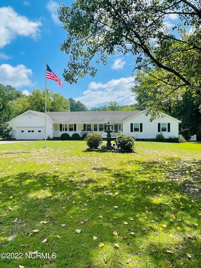 view of front facade featuring a front lawn and a garage