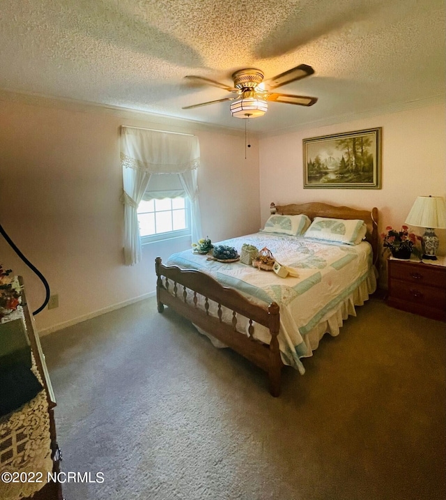 carpeted bedroom with a textured ceiling and ceiling fan