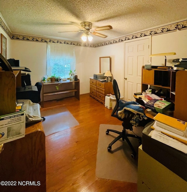 office area featuring hardwood / wood-style floors, a textured ceiling, and ceiling fan