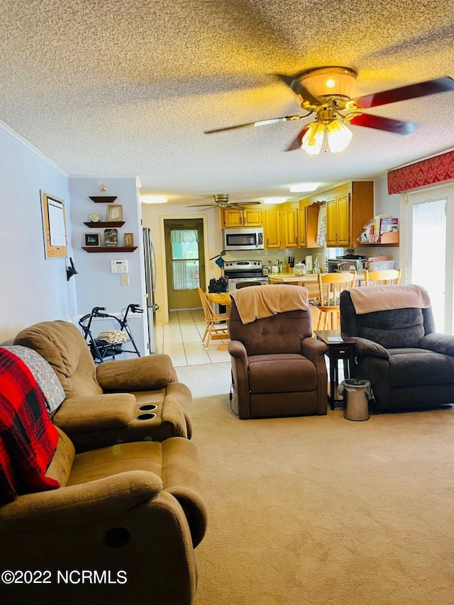 carpeted living room with a textured ceiling, crown molding, ceiling fan, and a wealth of natural light