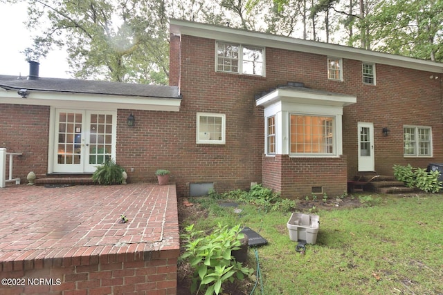 back of house featuring a patio, french doors, and a yard