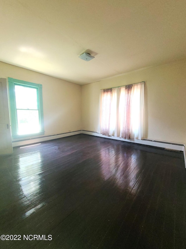 spare room featuring dark hardwood / wood-style flooring