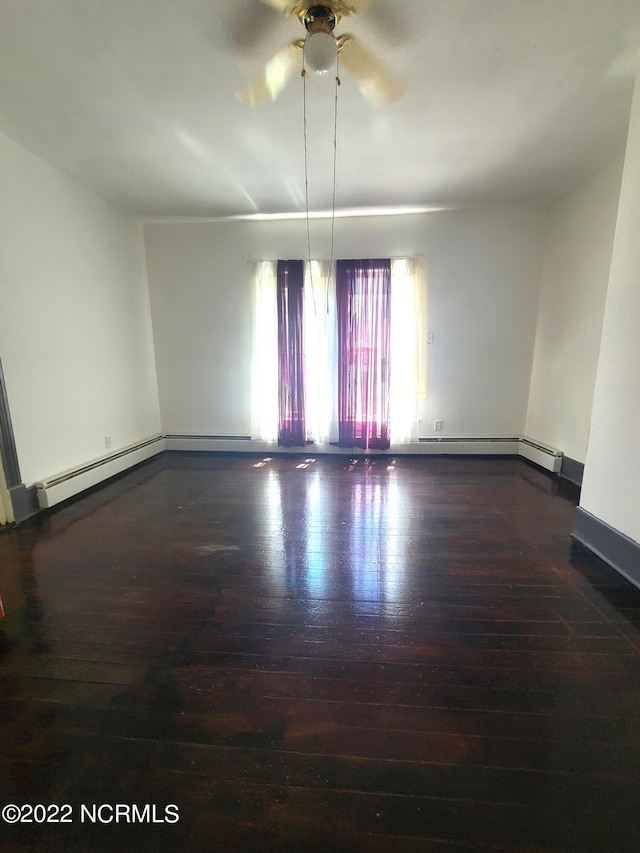 spare room featuring dark hardwood / wood-style floors and ceiling fan