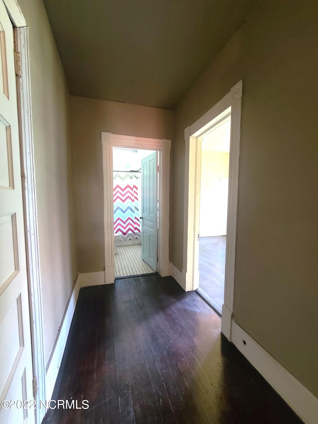 corridor with dark wood-type flooring