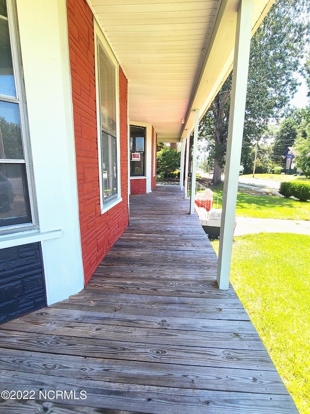 wooden terrace with a yard