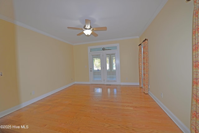 spare room featuring baseboards, light wood-type flooring, crown molding, and a ceiling fan