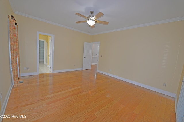 unfurnished room with visible vents, baseboards, ornamental molding, ceiling fan, and light wood-style floors