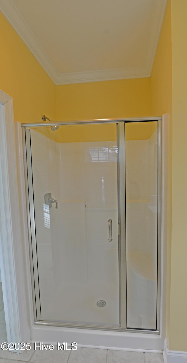 bathroom featuring a stall shower and crown molding