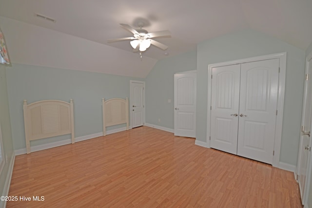 bonus room featuring visible vents, light wood-style flooring, lofted ceiling, and a ceiling fan