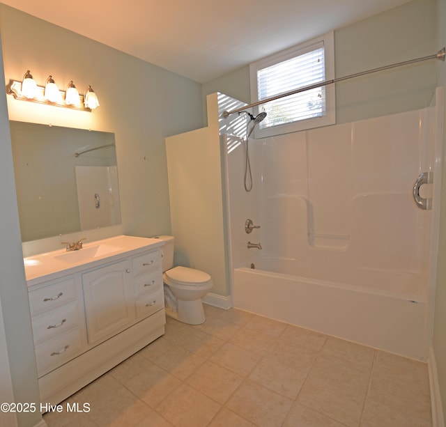 full bath featuring toilet, bathtub / shower combination, vanity, and tile patterned flooring