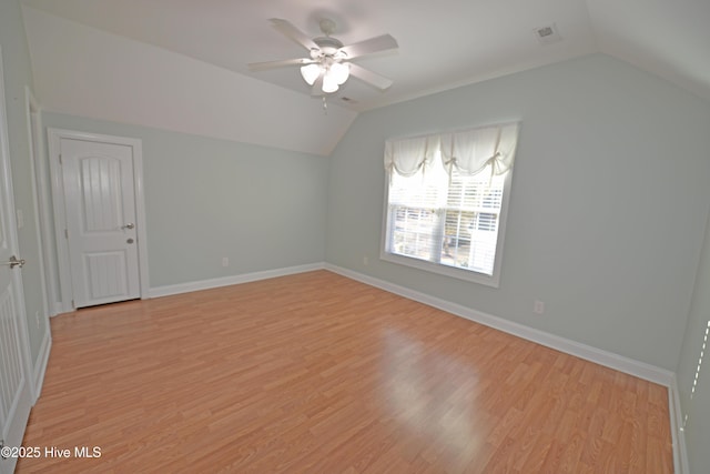 bonus room featuring a ceiling fan, vaulted ceiling, light wood-style floors, and baseboards