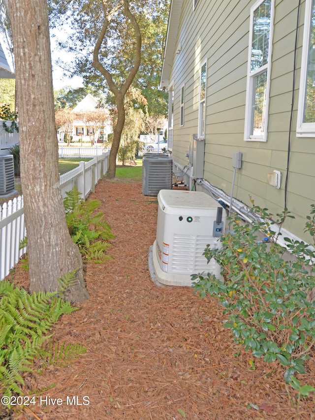 exterior space featuring cooling unit and fence