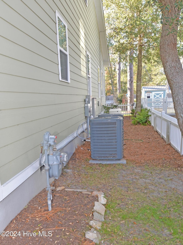 exterior details featuring central air condition unit and fence