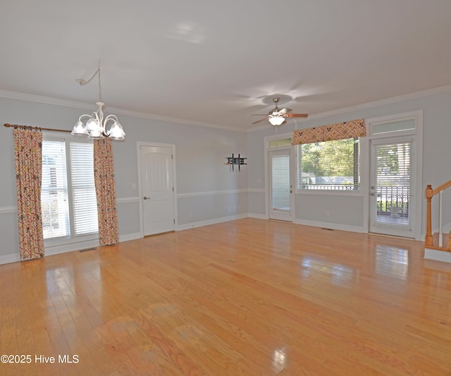 empty room featuring light wood-type flooring, a healthy amount of sunlight, and ornamental molding