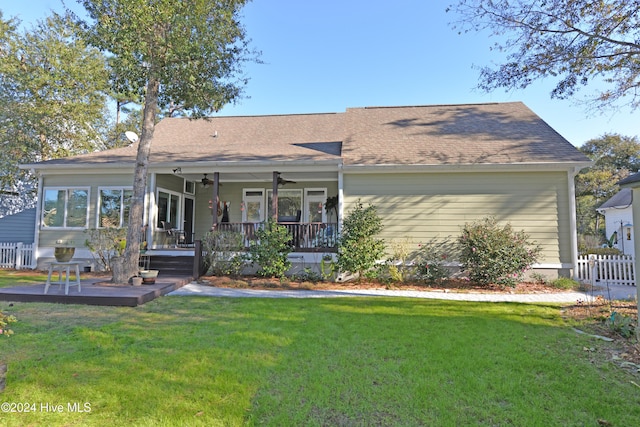 back of house with a ceiling fan, fence, a yard, covered porch, and a shingled roof