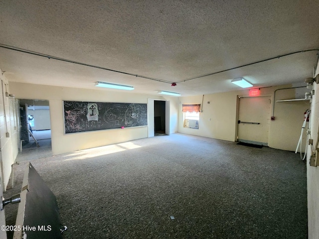 basement featuring a textured ceiling and carpet