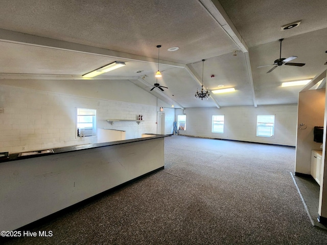 interior space with ceiling fan, a textured ceiling, and plenty of natural light