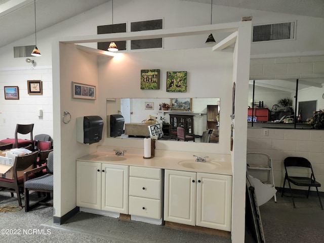 bar with sink, pendant lighting, and lofted ceiling