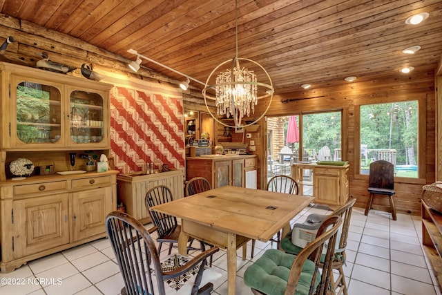 tiled dining room with a notable chandelier, wood ceiling, and wooden walls