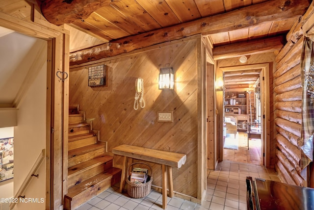 interior space with light tile floors, wood ceiling, log walls, and beamed ceiling