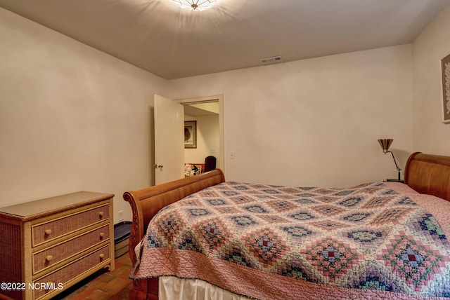 bedroom with dark hardwood / wood-style flooring