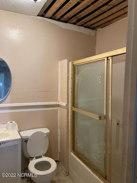 304 E Academy St, Robersonville, NC 27871 - full bathroom featuring shower / bath combination with glass door, wooden ceiling, vanity, and toilet