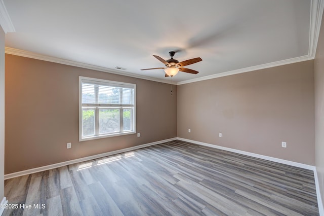 unfurnished room with wood finished floors, baseboards, a ceiling fan, and ornamental molding