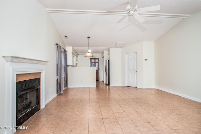 unfurnished living room featuring ceiling fan and light tile flooring