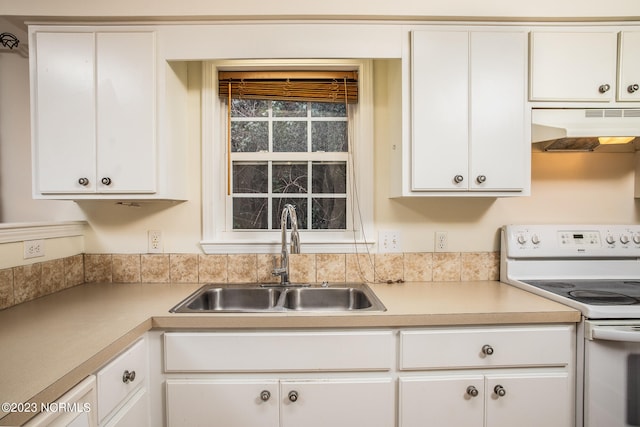 kitchen featuring white range with electric stovetop, sink, white cabinetry, and wall chimney exhaust hood