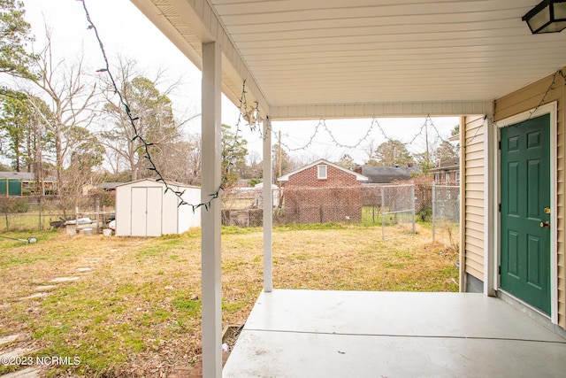 view of yard with a storage unit and a patio