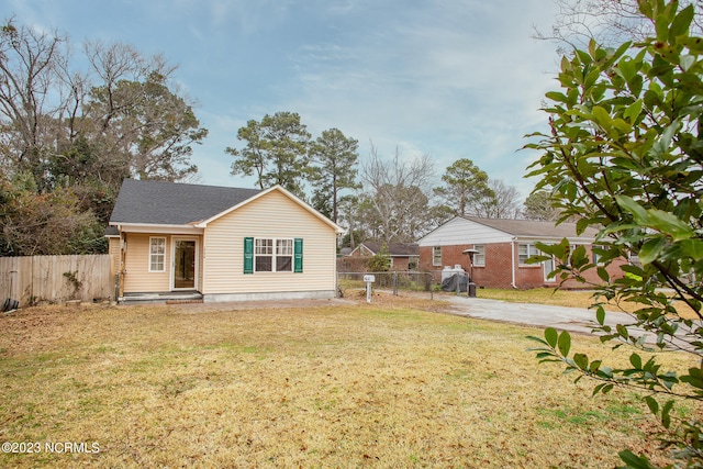 rear view of property featuring a lawn