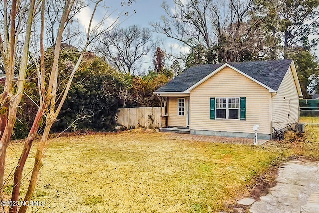 view of front of house featuring a front yard and central AC unit