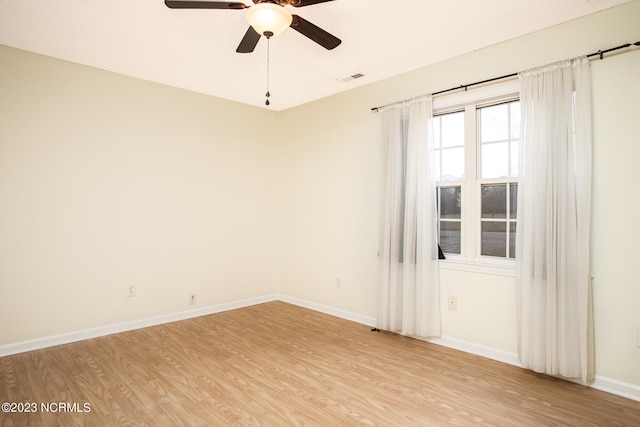 unfurnished room featuring light hardwood / wood-style floors and ceiling fan