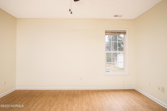 spare room with ceiling fan and light wood-type flooring