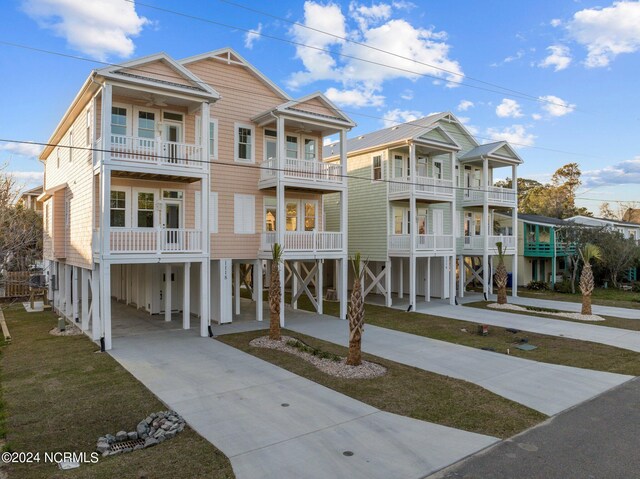 view of front of house with a balcony and a carport