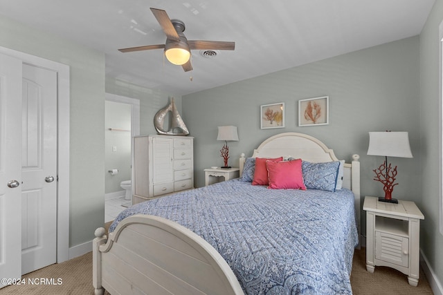 carpeted bedroom featuring ceiling fan and ensuite bathroom