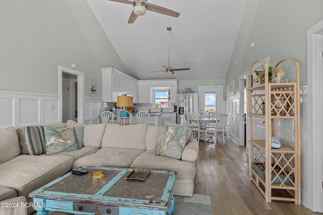 living room featuring ceiling fan, hardwood / wood-style flooring, and high vaulted ceiling