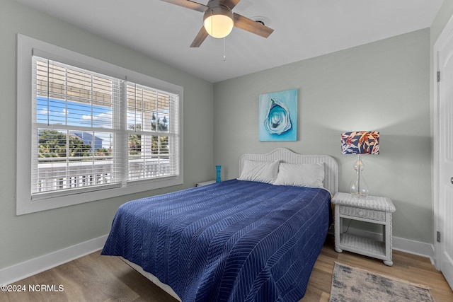 bedroom with ceiling fan and hardwood / wood-style floors