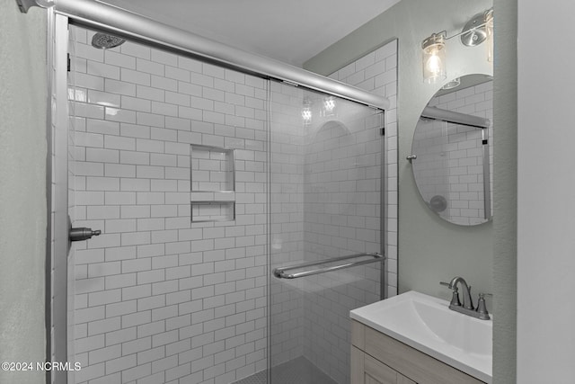 bathroom featuring vanity and a shower with door