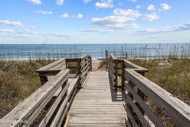 surrounding community featuring a water view and a view of the beach