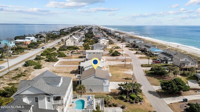 bird's eye view with a water view and a beach view