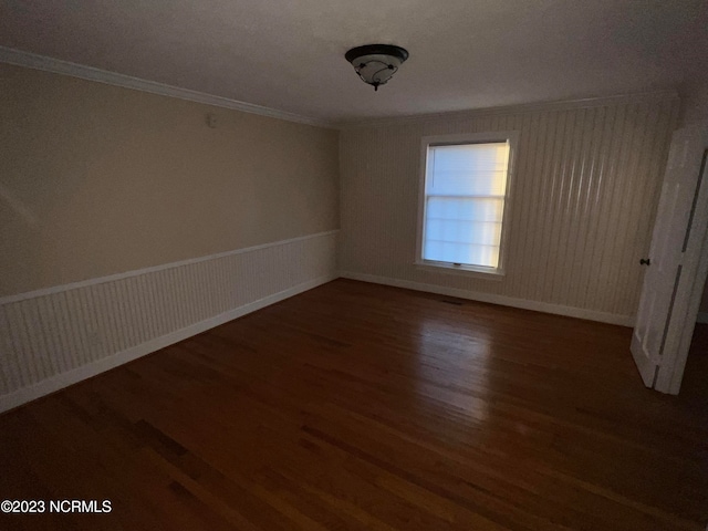 unfurnished room with dark hardwood / wood-style flooring and ornamental molding