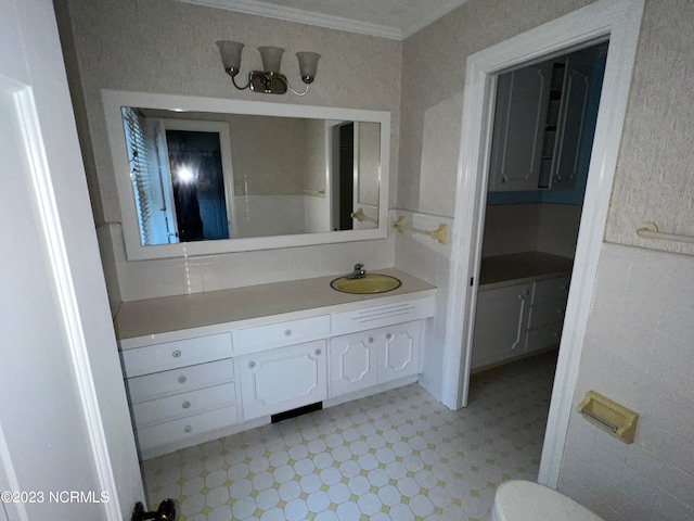 bathroom featuring tile floors, vanity, and crown molding