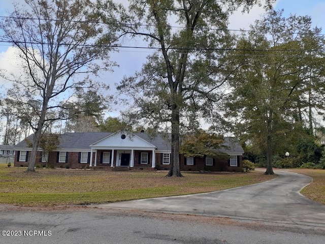 neoclassical home with a front lawn