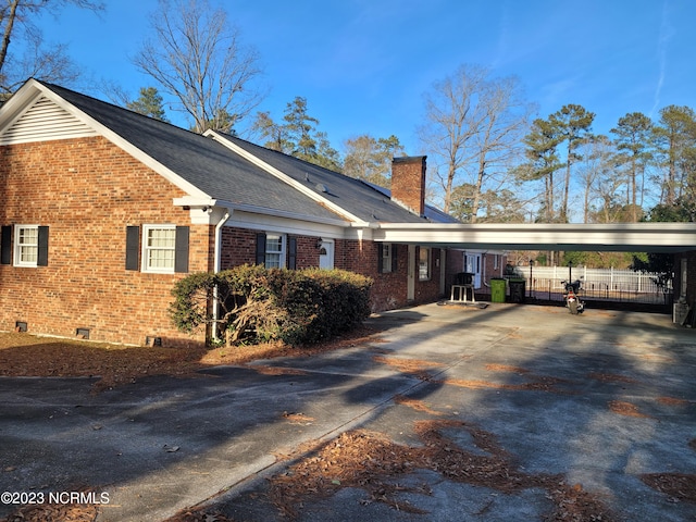 view of property exterior featuring a carport
