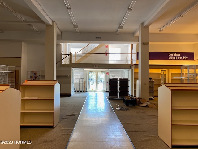 entrance foyer featuring dark tile flooring and french doors