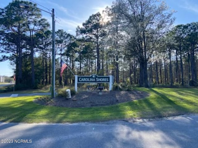 community / neighborhood sign with a lawn